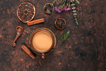 Cup of coffee with cinnamon and flowers on an old rusty table, grunge.Autumn flower arrangement, abstract background flat lay, minimal concept of holiday, thanksgiving day, postcard.