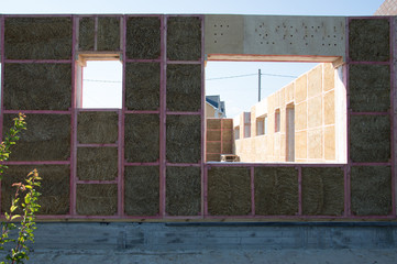 Construction of a house from an environmentally friendly material of plant origin. Frame made of wood, blocks of straw.