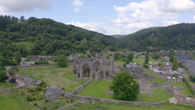 Aerial drone of Tintern Abbey, with Tintern and the River Wye in the background
