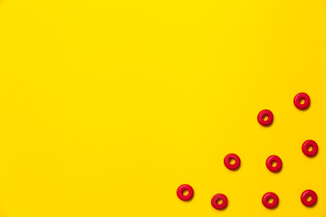 On a yellow background, there are rings of red color of the same size, which form a frame on children's education and development. Backdrop for placing text and other information