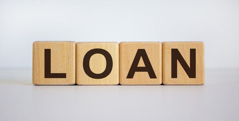 Concept word 'loan' on cubes on a beautiful white background. Business concept, copy space.