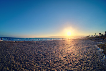 Sunset at sandy beach of Mediterranean sea