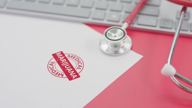 Putting MEDICAL MARIJUANA stamp on the paper