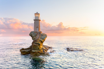 The beautiful Lighthouse Tourlitis of Chora at night. Andros island, Cyclades, Greece