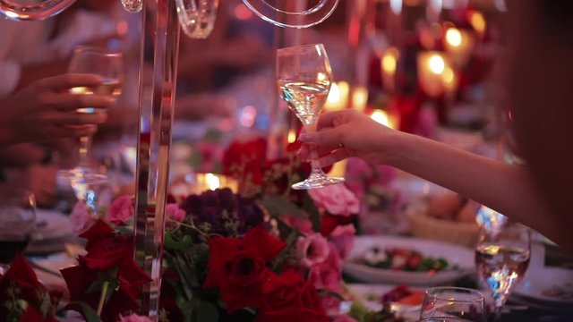 People clinking glasses at party. celebration on event. Festive table in a restaurant, people have dinner.