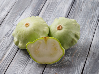 Pattypan squash on old rustic wooden background.