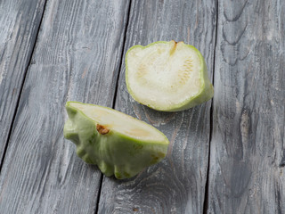 Dissected pattypan squash on old rustic wooden background.