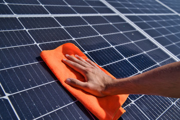 
Cleaning of solar panels. Hand wipes solar panels from dirt.