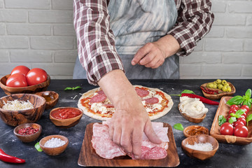 Pizza preparation with chef hands