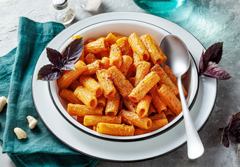 pasta with baked peppers and cashews sauce. vegan full-fledged healthy lunch or dinner with purple basil