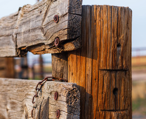 Old wooden fence post and fencing on a working farm near Denver on a late summer afternoon