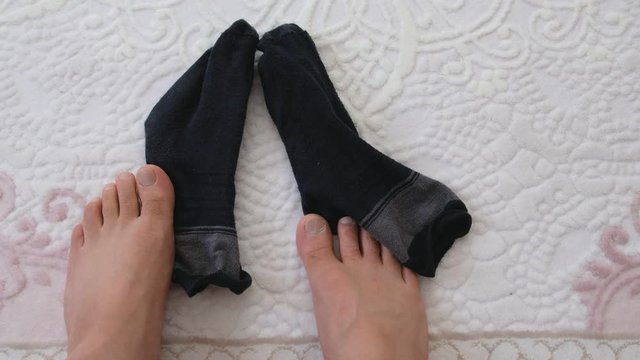 body fatigue, tired and sleepy person who does not want to wear socks.
