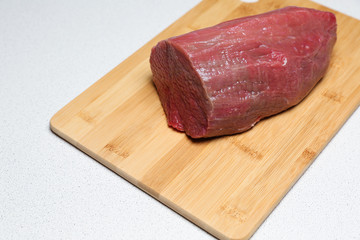 a piece of raw beef on a cutting board