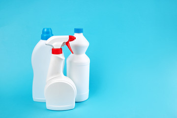 group of blank detergent product bottles over blue background. copy space. cleaning and washing equipment concept