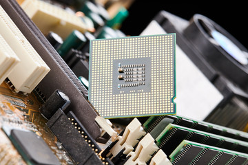 cpu processor hardware unit over motherboard background. computer chip close up. digital technology concept