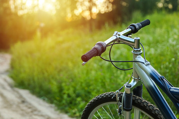 Fototapeta na wymiar beautiful mountain bicycle on green nature background on sunset