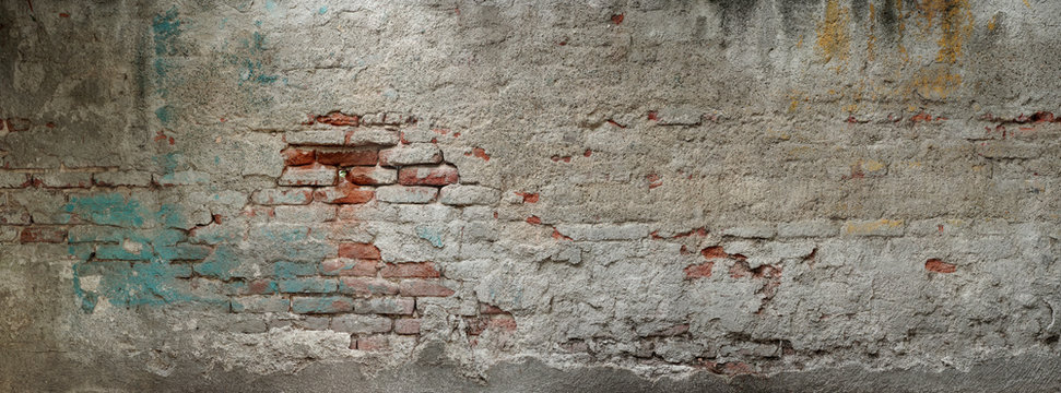 Old brick wall banner. Painted Distressed Wall Surface. Grungy texture. Grunge wall background. Building facade with damaged plaster.