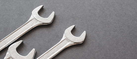 Set of 3 Wrenches on a Dark Textured Background