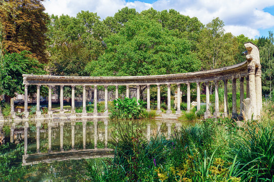 The famous classical roman colonnade in the Parc Monceau with relection in the pond - Paris, France. The garden designed by Carmontelle was finished in 1779.