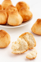 Vegan homemade coconut cookies on white wooden background.