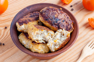 Juicy homemade fish cutlets on wooden background. Top view
