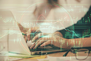 Multi exposure of woman hands typing on computer and financial graph hologram drawing. Stock market analysis concept.