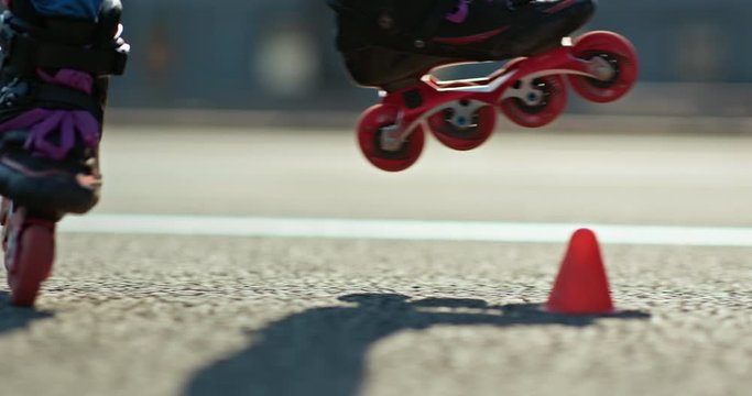 Close-up of the roller's legs circling the cones. Roller skating is a professional element in roller skating. 4k, 10bit, ProRes