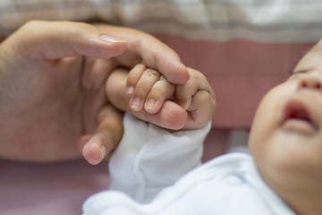 Asian New Born baby boy holding mother's hand. Love family healthcare and medical body part father's day concept panoramic banner