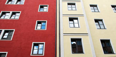 Fototapeta na wymiar Colorful building facade with windows. Bicolor architecture in Munich