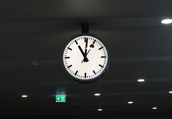 A big white wall clock at train station