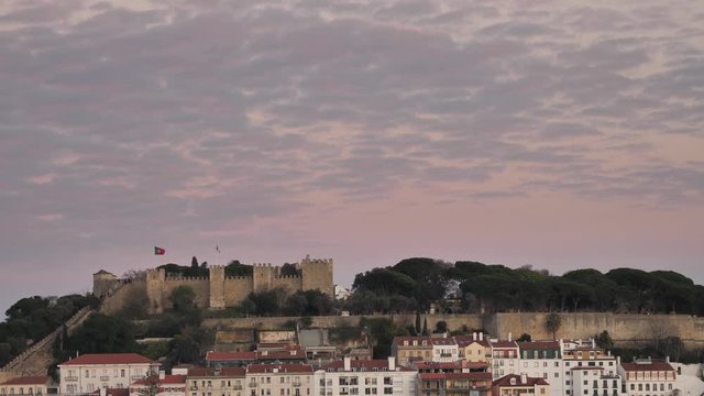 Beautiful Purple Sunset Behind The Sao Jorge Castle in Lisbon Portugal