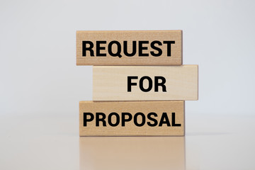 Request for proposal written on wood block on white background.