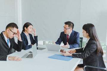 Asian company meetings for presentation as statistical graphs. The business team team consulted each other about the marketing stress.