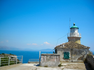 Fototapeta na wymiar An old lighthouse against the sky at the top of Corfu fortress