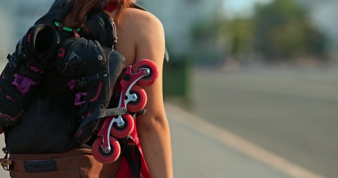 Close-up, a backpack with roller skates. Woman carries roller skates for training. 4k, 10bit, ProRes