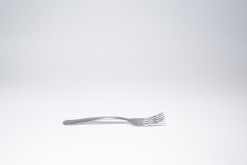 Traditional metal fork on the white background