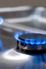 Macro Shoot of Two Gas Burners on Stove Surface with Flames.
