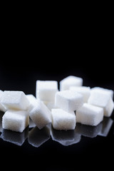 Macro Shoot of White Cube Sugar Placed Bulk Against Black Background.