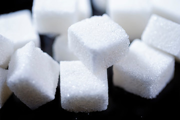 Closeup Macro Shoot of White Cube Sugar Placed Bulk Against Black Background.