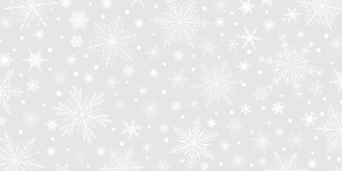 Naklejka na ściany i meble Christmas background of various complex big and small snowflakes, white on gray