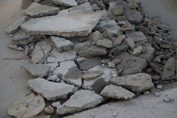 Broken rock fragment, The cement floor was broken into pieces.