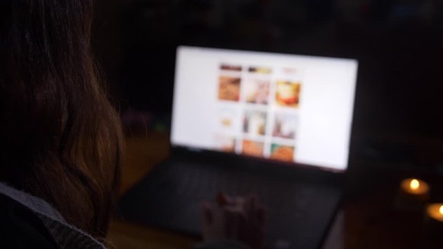 Young Woman Using Laptop at night