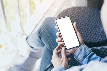 cell phone mockup image blank white screen.woman hand holding texting using mobile on desk at coffee shop.background empty space for advertise.work people contact marketing business,technology