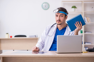 Young male doctor working in the clinic