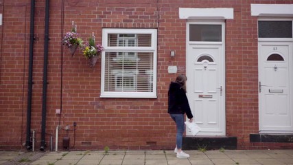 Girl safely dropping off a care package to grandparent's house | Wide shot (Slow motion) - Powered by Adobe
