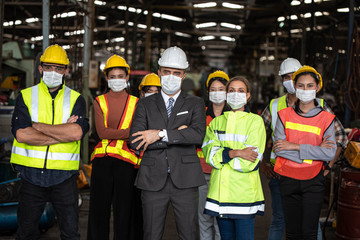 Group of industrial staff worker consist of Technicians, Engineers and factory Manager wearing...