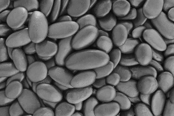 Natural black pebbles or stone gravel texture background.