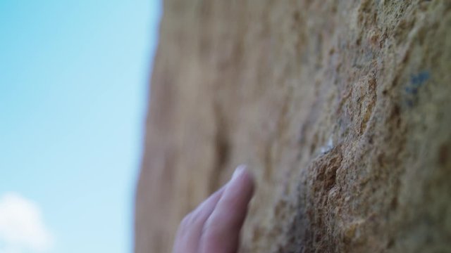 Close up of fingers of climber gripping rock hold in steep Smith Rock wall