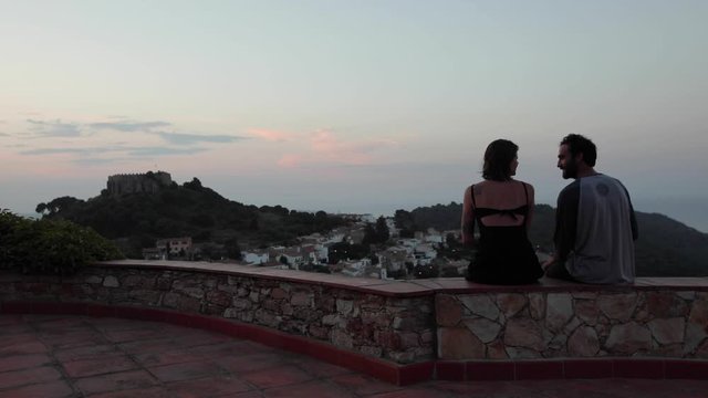 Couple looking at sunset, enjoying view, beautiful, talk, kiss, love