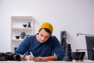 Young male photographer working in the studio